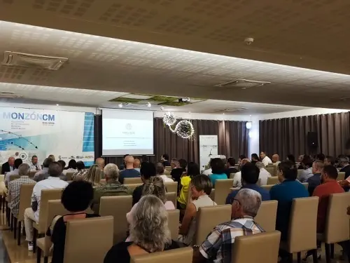 A public meeting about the project in a hall in Monzón