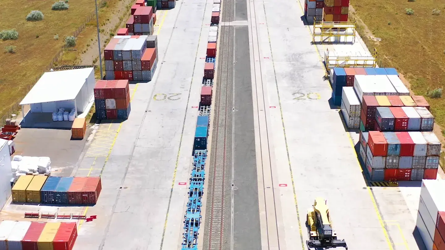 The rail freight terminal at Monzón, containers stacked beside the track